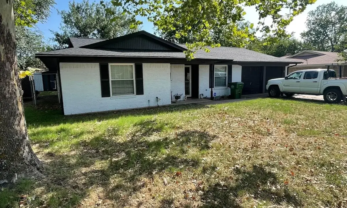 Professional roofing crew working on a residential roof in Moline